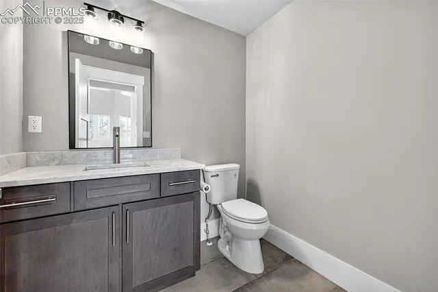 a view of an empty room with wooden floor and windows