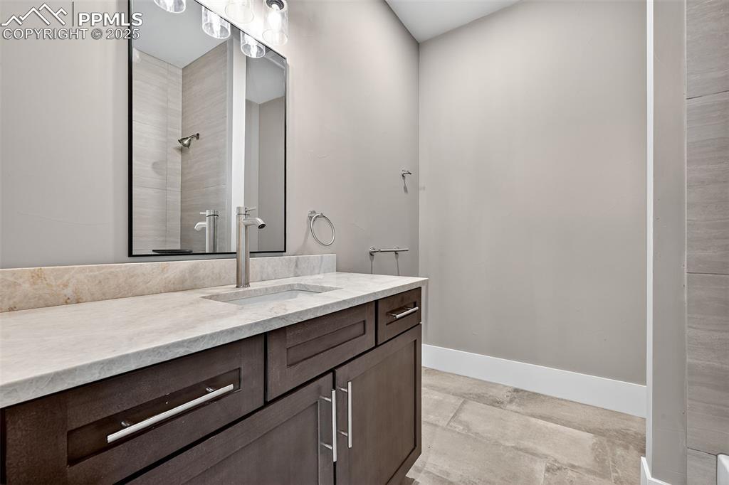 485 Cardiff Circle Colorado Springs, CO 80906 - Photo 23 of 50 a bathroom with a sink and a mirror