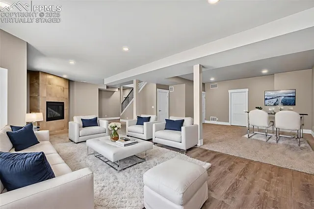 a living room with furniture and kitchen view