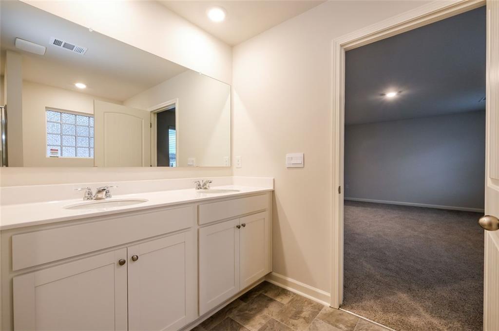 14 Canterbury Valley Braselton, GA 30517 - Photo 13 of 25 a bathroom with a double vanity sink and a mirror