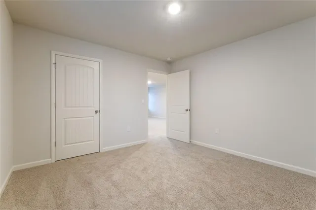a view of an empty room and closet area