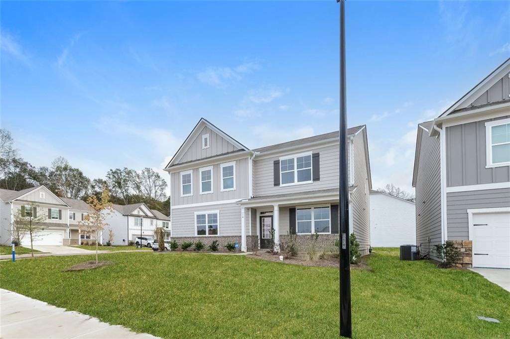 14 Canterbury Valley Braselton, GA 30517 - Photo 2 of 25 a front view of a house with a garden