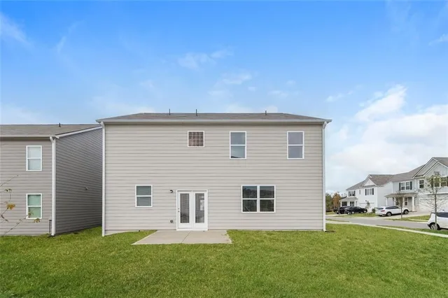 a backyard of a house with table and chairs