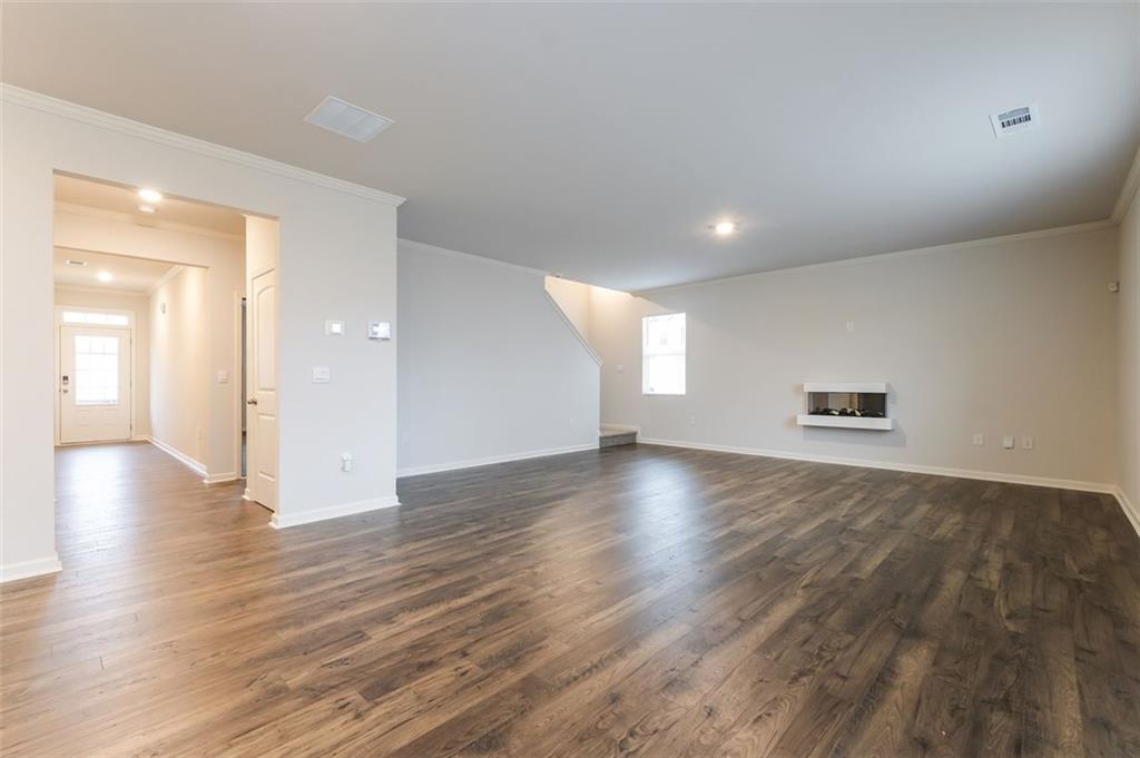 14 Canterbury Valley Braselton, GA 30517 - Photo 5 of 25 an empty room with wooden floor and windows