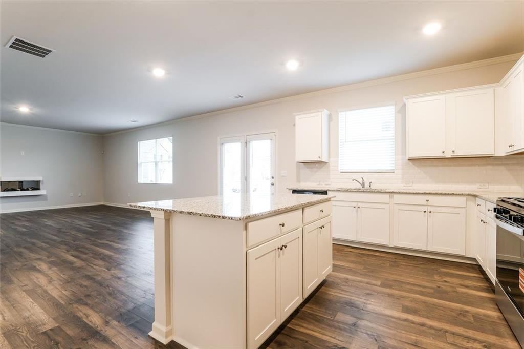 14 Canterbury Valley Braselton, GA 30517 - Photo 8 of 25 a kitchen with granite countertop white cabinets white appliances a sink and a window