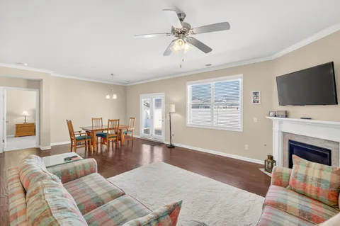 a living room with furniture fireplace and flat screen tv