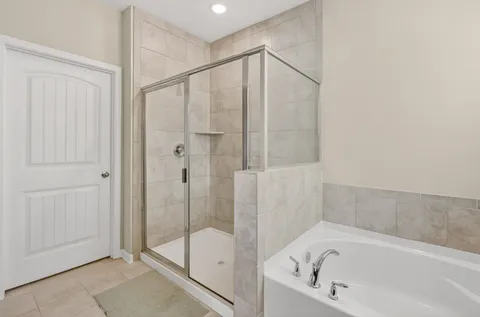 a bathroom with a bathtub and a shower