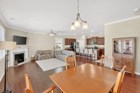 a living room with fireplace furniture and a flat screen tv