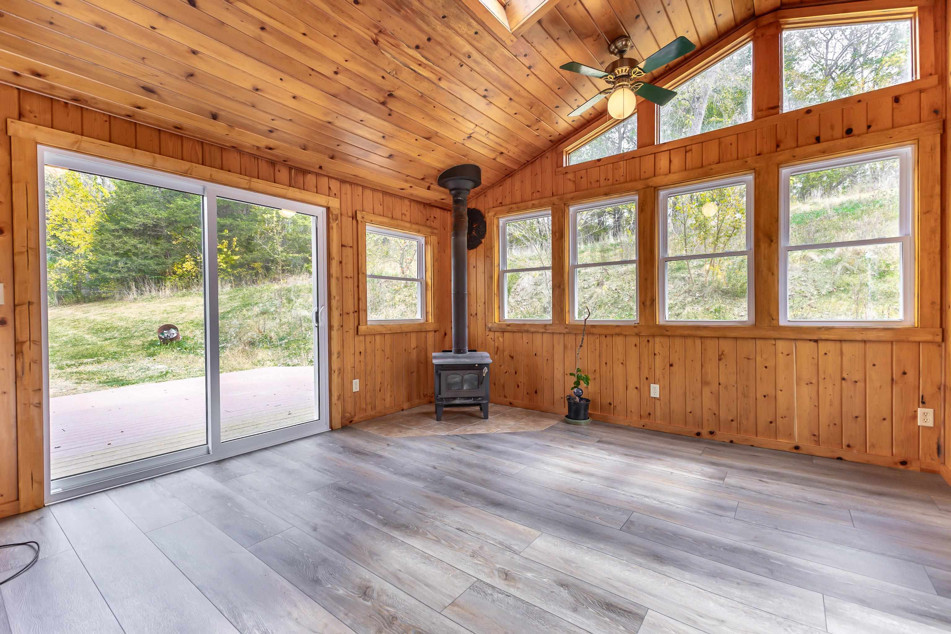 151 North Blackjack Road Galena, IL 61036 - Photo 13 of 65 an empty room with wooden floor and windows