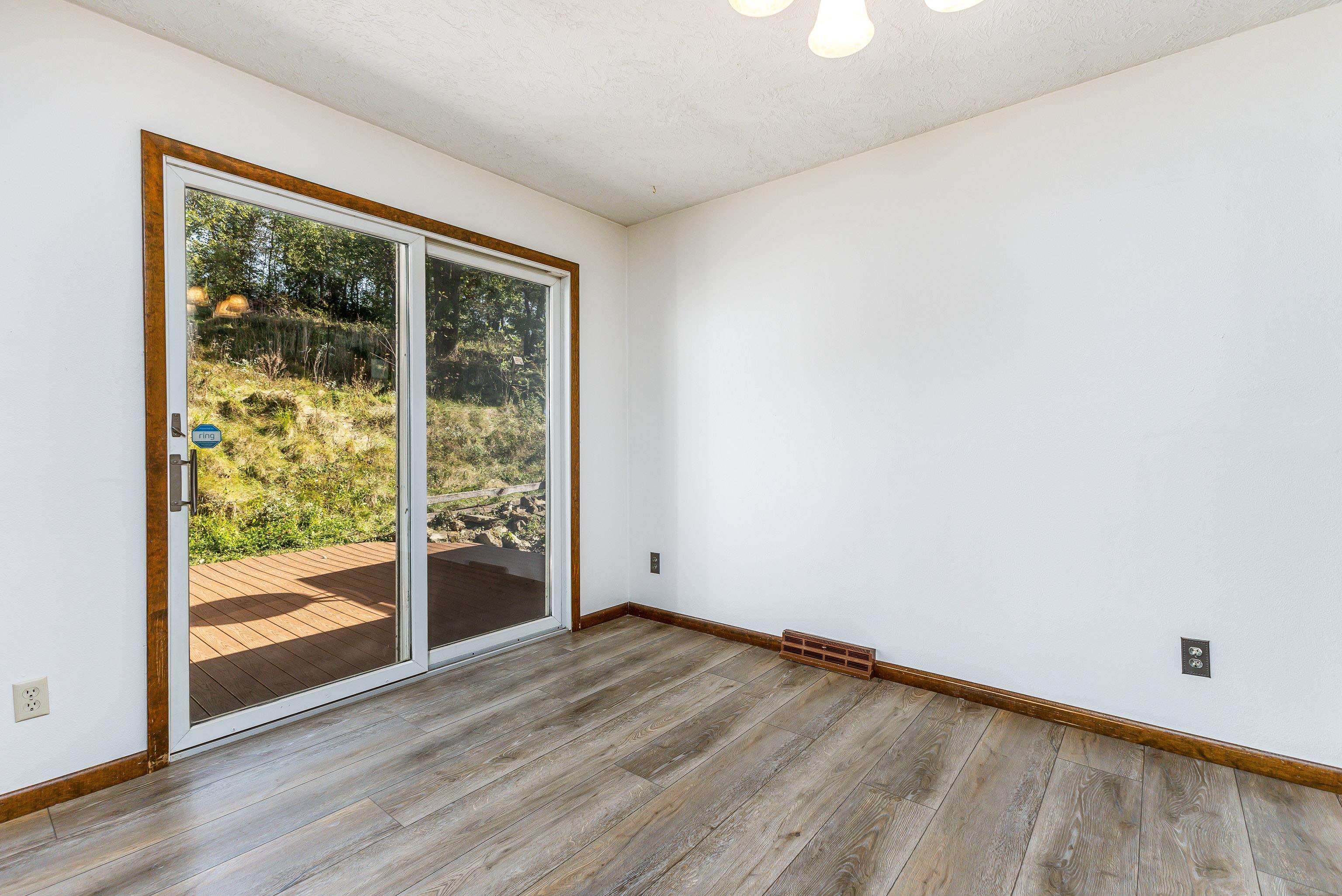 151 North Blackjack Road Galena, IL 61036 - Photo 19 of 65 a view of an empty room with wooden floor and a window