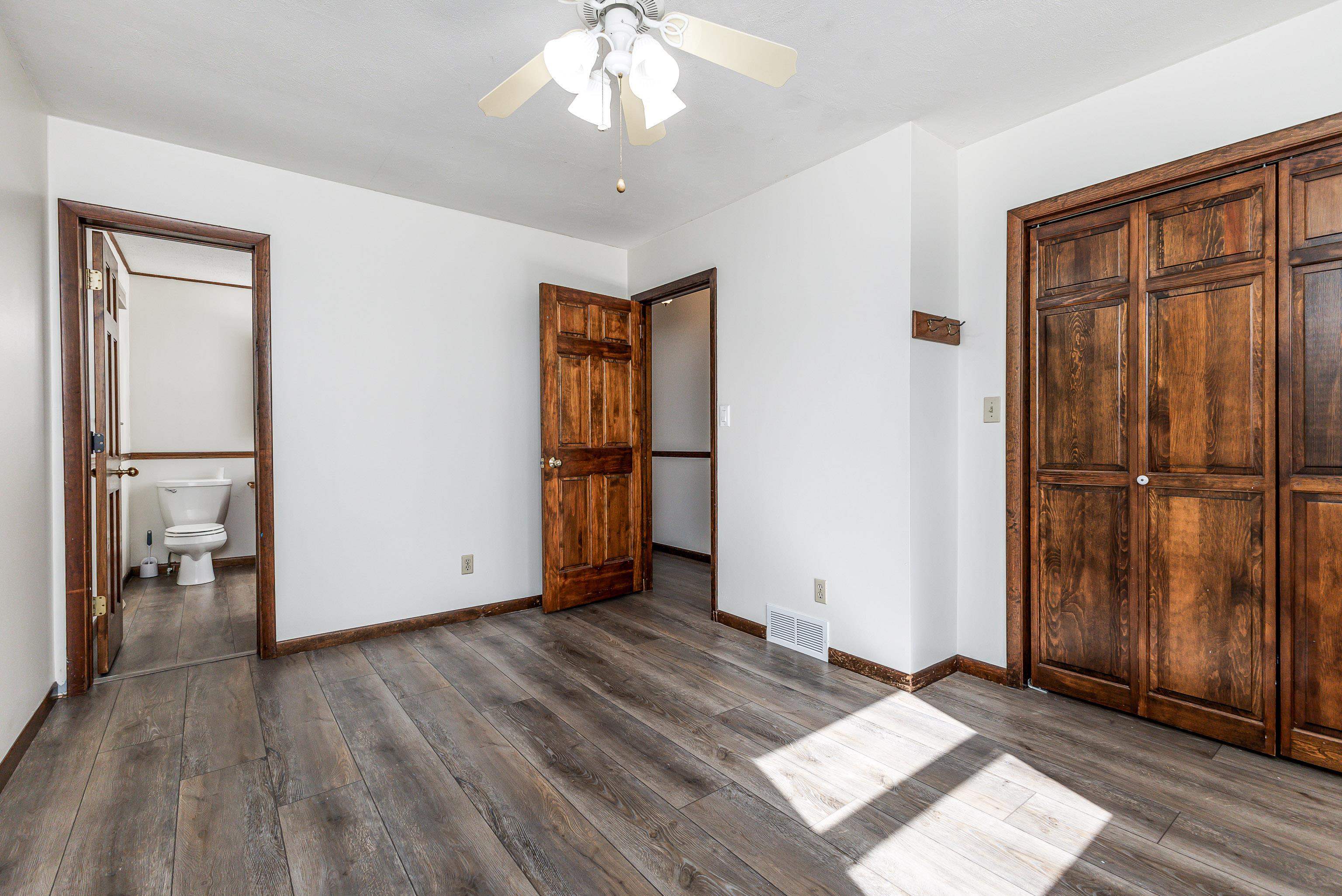 151 North Blackjack Road Galena, IL 61036 - Photo 23 of 65 an empty room with wooden floor cabinet and windows