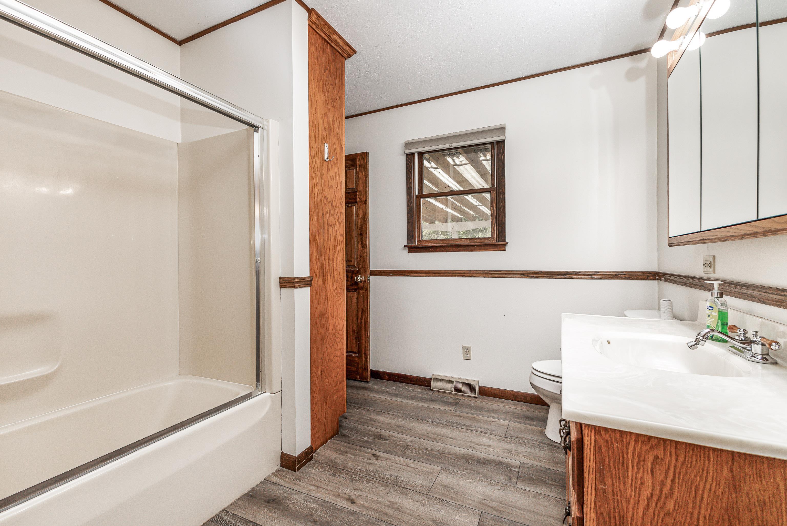 151 North Blackjack Road Galena, IL 61036 - Photo 25 of 65 a bathroom with a bathtub a sink and a mirror