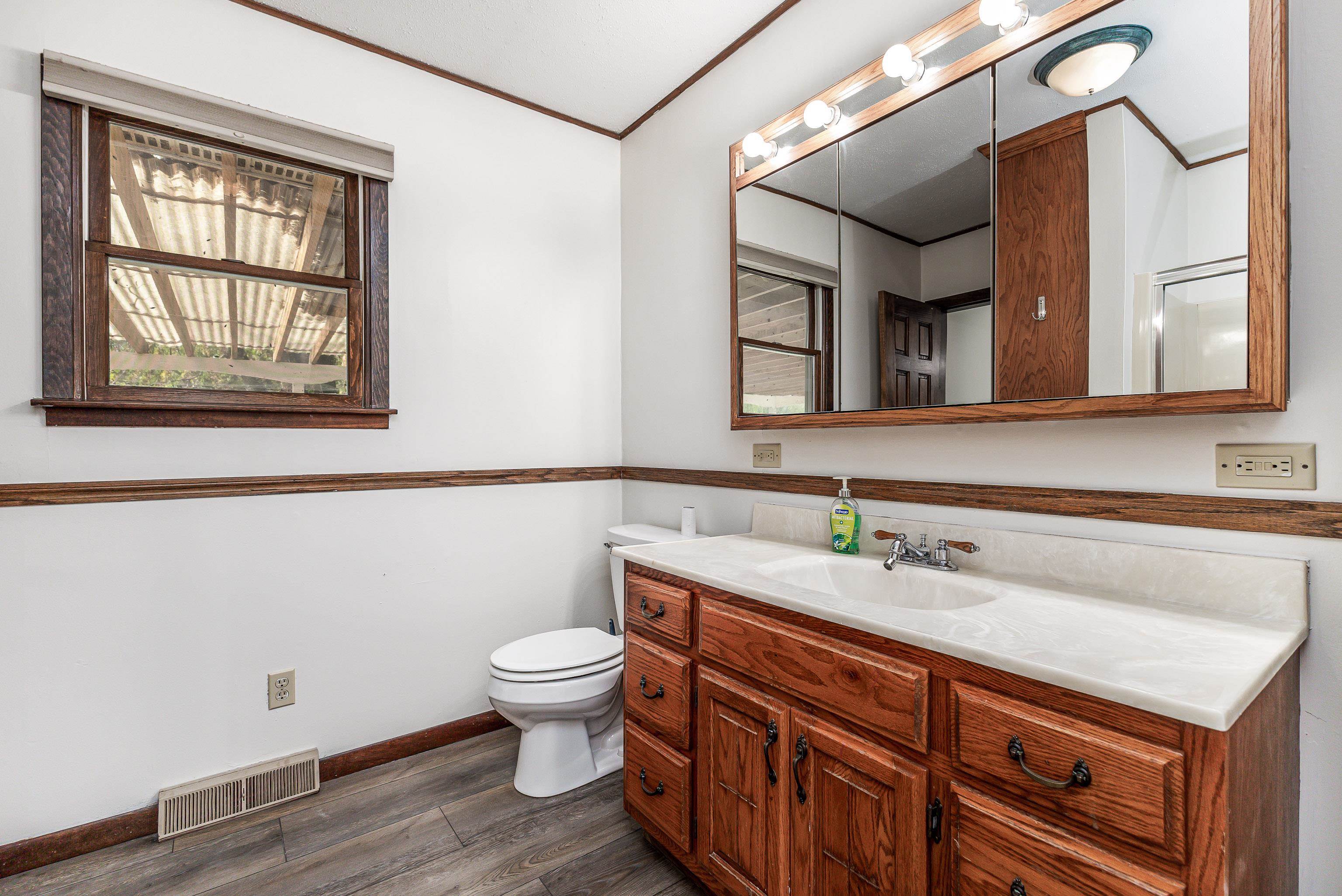 151 North Blackjack Road Galena, IL 61036 - Photo 26 of 65 a bathroom with a sink a toilet and mirror