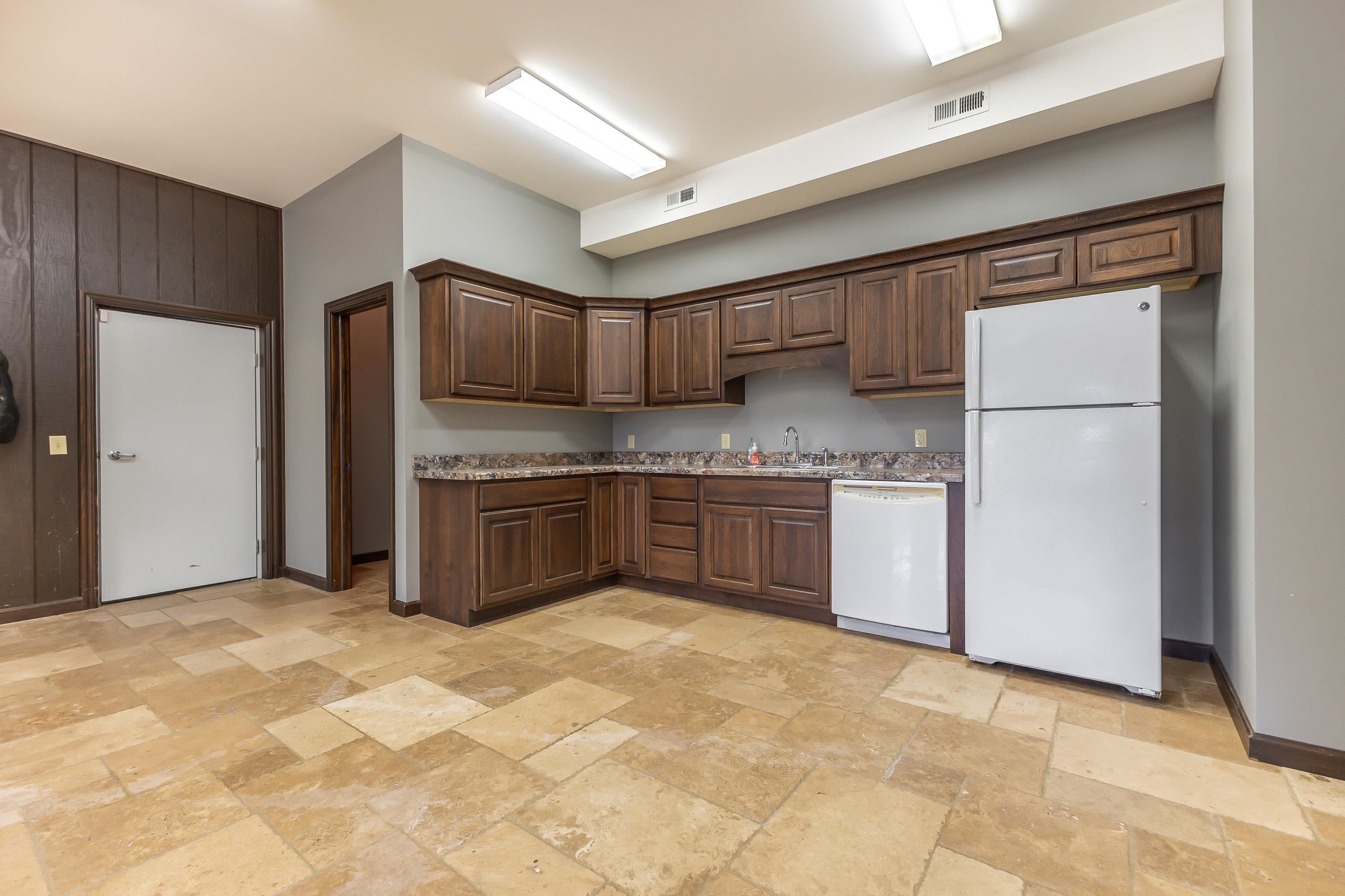 151 North Blackjack Road Galena, IL 61036 - Photo 46 of 65 a kitchen with kitchen island granite countertop a stove a sink and a refrigerator