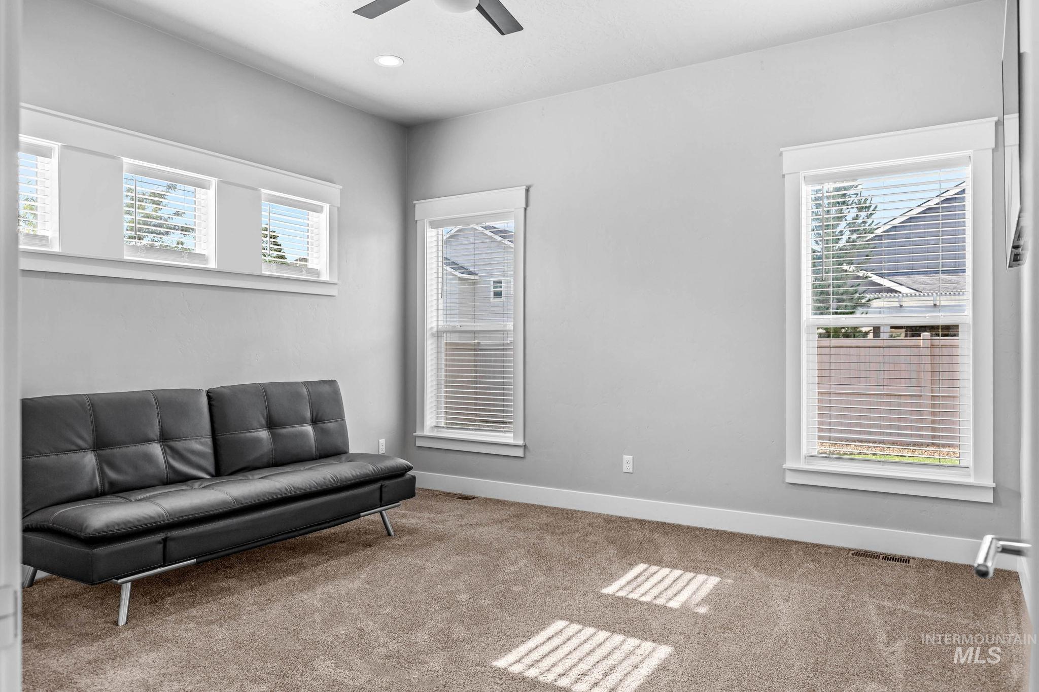 2934 East Murchison Street Meridian, ID 83642 - Photo 21 of 44 Carpeted room featuring multiple windows with blinds, recessed lighting, and a ceiling fan