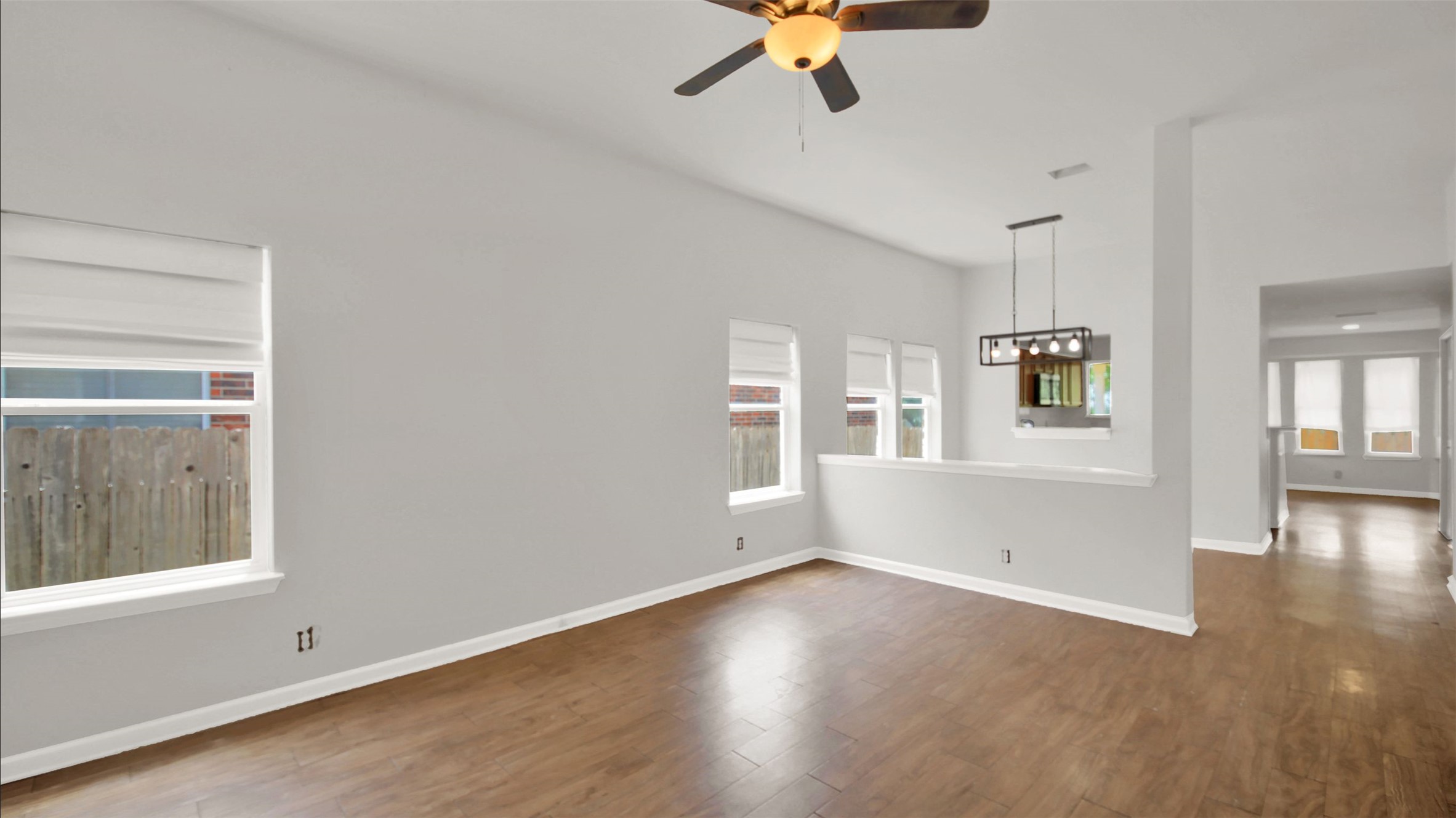1609 Harness Raceway Street Pflugerville, TX 78660 - Photo 7 of 32 A living space offers continuous hardwood flooring and natural illumination from multiple windows.