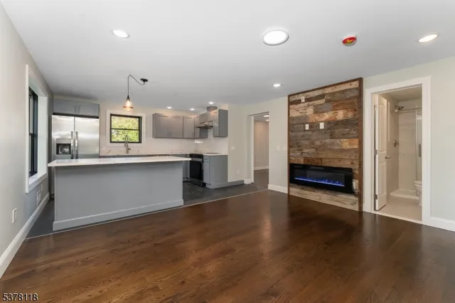 a view of a kitchen with wooden floor and a window