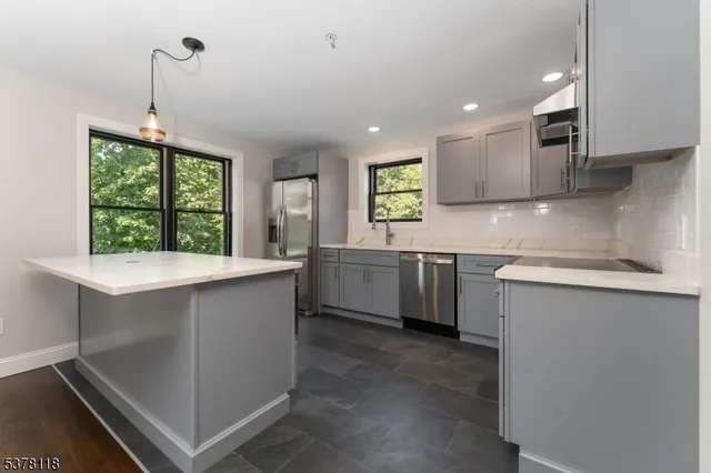 a kitchen with a sink window and cabinets