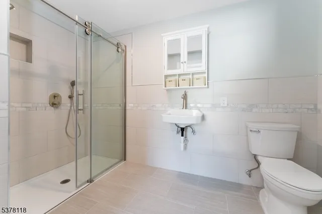 a bathroom with a toilet a sink and shower