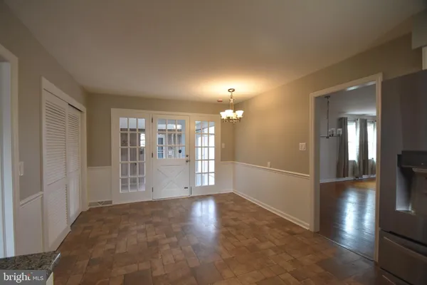 a view of livingroom with hardwood floor and kitchen view