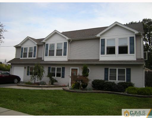 10 Sturgis Road Edison, NJ 08817 - Photo 2 of 9 a front view of a house with a yard and garage