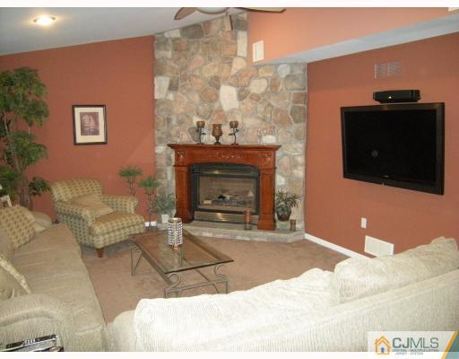 10 Sturgis Road Edison, NJ 08817 - Photo 7 of 9 a living room with furniture and a fireplace