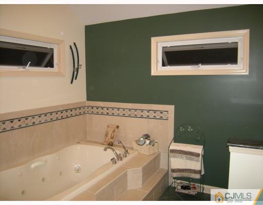 10 Sturgis Road Edison, NJ 08817 - Photo 9 of 9 a bathroom with a bathtub and a window