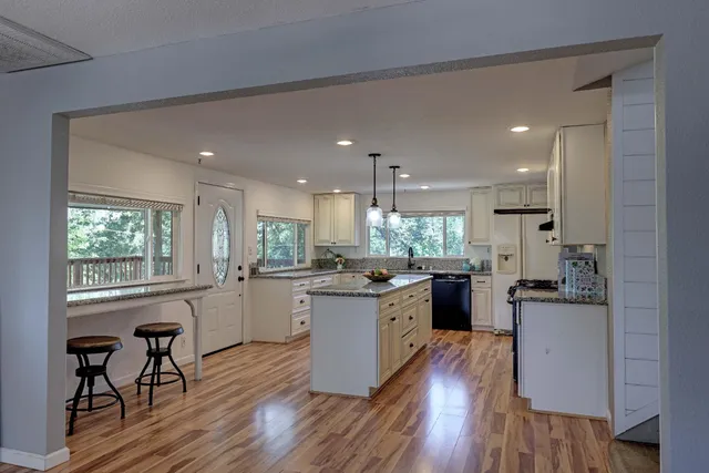 a kitchen with granite countertop a sink and a window