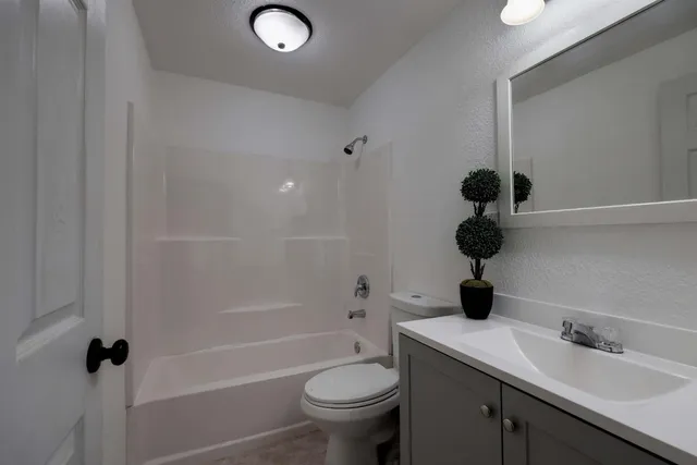 a view of deck and a yard with wooden fence
