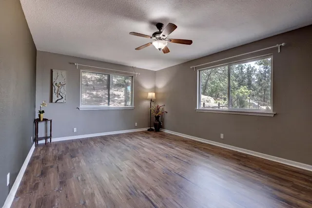 a view of balcony with wooden floor and fence
