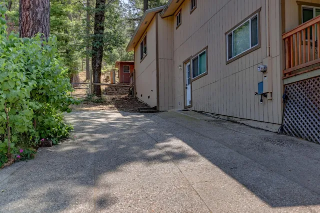 a view of a swimming pool with a yard and plants