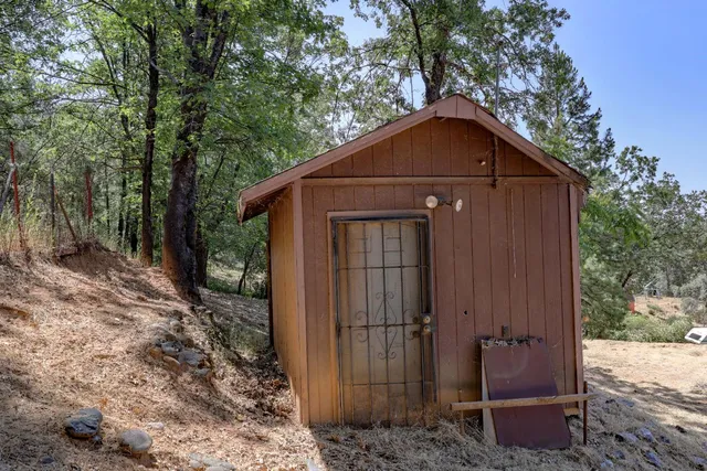 a wooden bench sitting in the middle of a yard