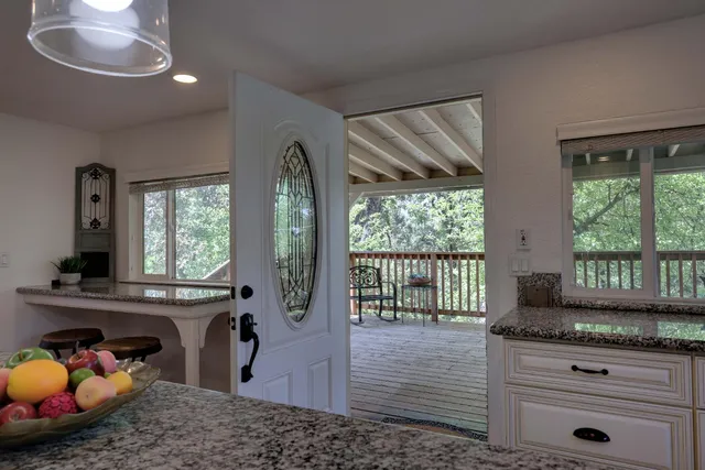 a large kitchen with stainless steel appliances granite countertop a sink a stove and a granite counter tops