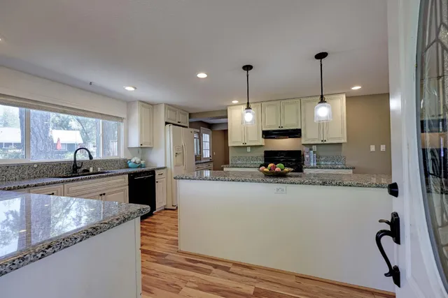 a kitchen with a sink and a large window
