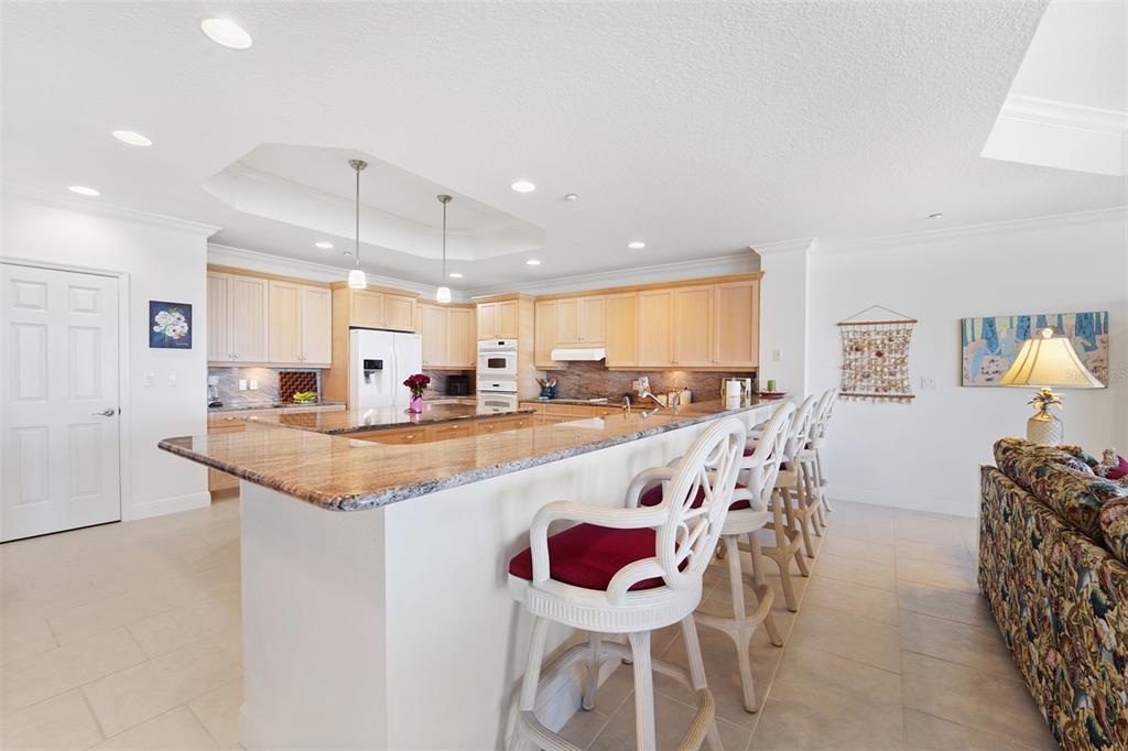 17735 Gulf Boulevard, Unit 702 Redington Shores, FL 33708 - Photo 15 of 60 a large kitchen with a table and chairs