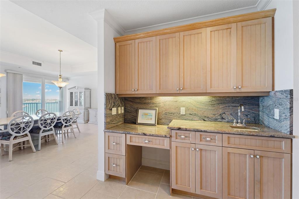 17735 Gulf Boulevard, Unit 702 Redington Shores, FL 33708 - Photo 17 of 60 a kitchen with stainless steel appliances granite countertop a stove a sink and a microwave