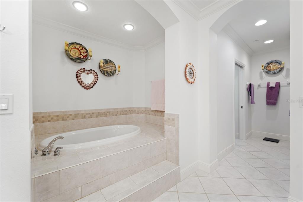 17735 Gulf Boulevard, Unit 702 Redington Shores, FL 33708 - Photo 22 of 60 a bathroom with a bath tub and shower