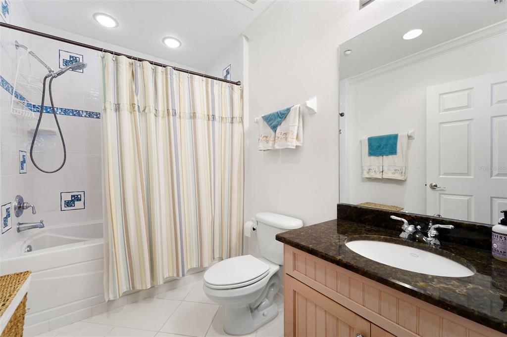 17735 Gulf Boulevard, Unit 702 Redington Shores, FL 33708 - Photo 29 of 60 a bathroom with a granite countertop sink and a mirror