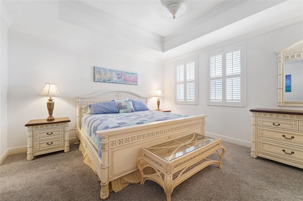 17735 Gulf Boulevard, Unit 702 Redington Shores, FL 33708 - Photo 30 of 60 a spacious bedroom with a bed and a dresser