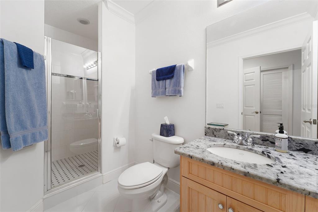 17735 Gulf Boulevard, Unit 702 Redington Shores, FL 33708 - Photo 31 of 60 a bathroom with a granite countertop sink toilet and shower