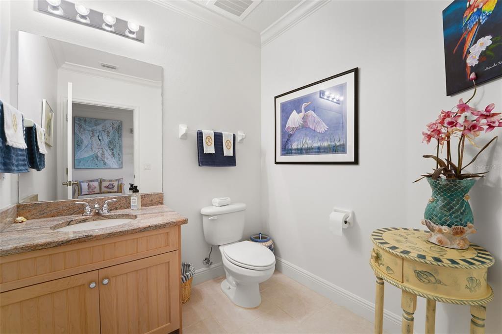 17735 Gulf Boulevard, Unit 702 Redington Shores, FL 33708 - Photo 32 of 60 a bathroom with a toilet a sink and a mirror