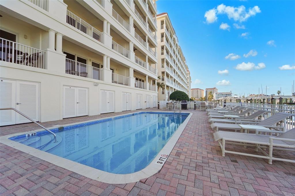 17735 Gulf Boulevard, Unit 702 Redington Shores, FL 33708 - Photo 40 of 60 a view of a swimming pool with a lounge chairs