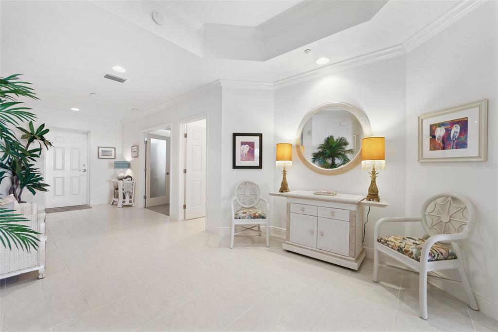 17735 Gulf Boulevard, Unit 702 Redington Shores, FL 33708 - Photo 4 of 60 a living room with furniture a mirror and white walls