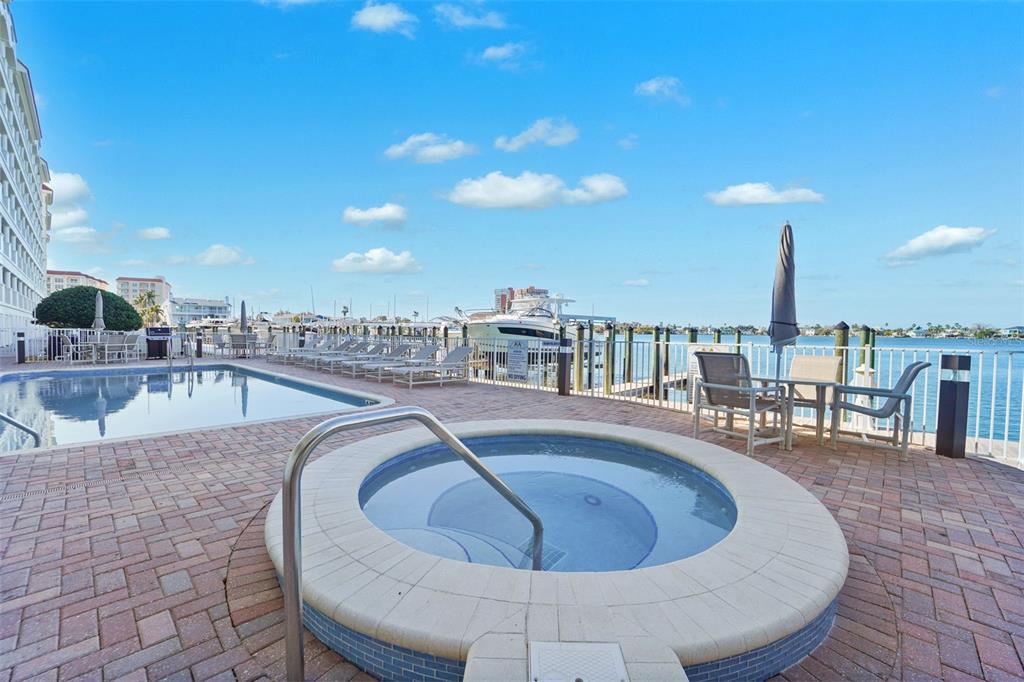 17735 Gulf Boulevard, Unit 702 Redington Shores, FL 33708 - Photo 41 of 60 a view of a swimming pool with outdoor seating