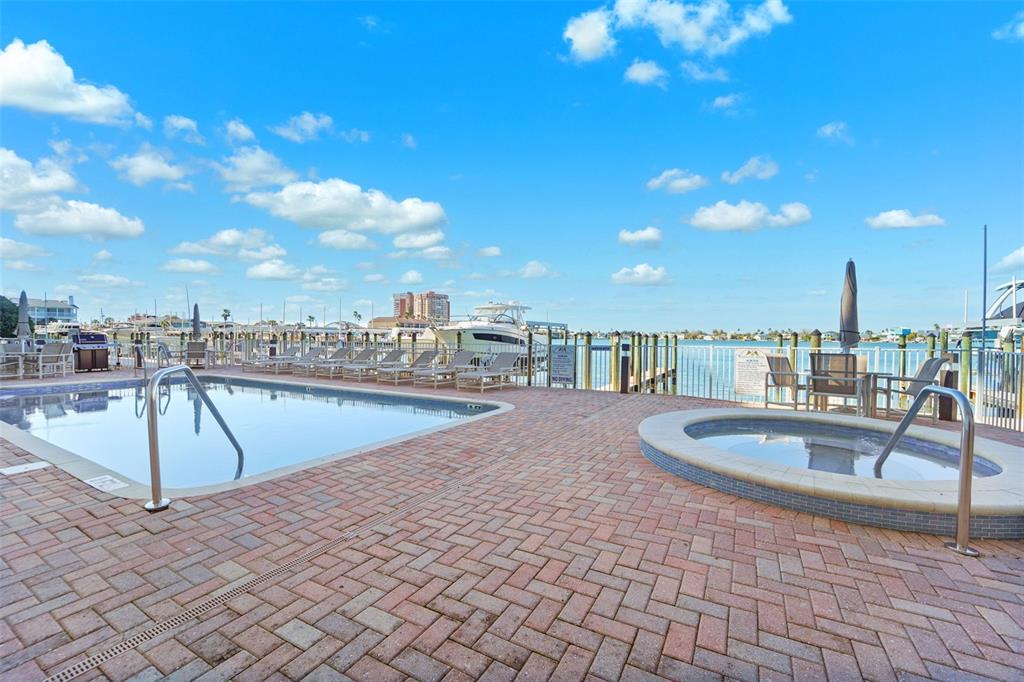 17735 Gulf Boulevard, Unit 702 Redington Shores, FL 33708 - Photo 42 of 60 a view of a swimming pool with a lounge chairs