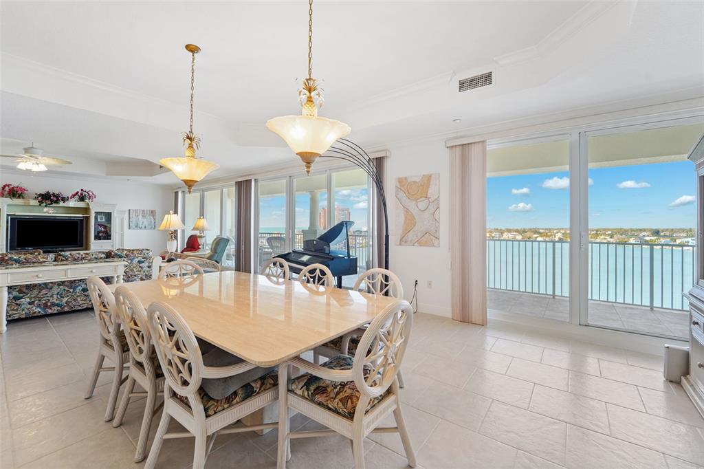 17735 Gulf Boulevard, Unit 702 Redington Shores, FL 33708 - Photo 7 of 60 a view of a dining room and livingroom with furniture wooden floor a chandelier