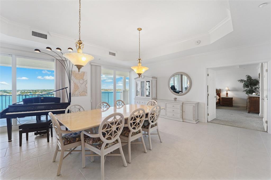 17735 Gulf Boulevard, Unit 702 Redington Shores, FL 33708 - Photo 9 of 60 a view of a dining room and livingroom with furniture wooden floor a chandelier