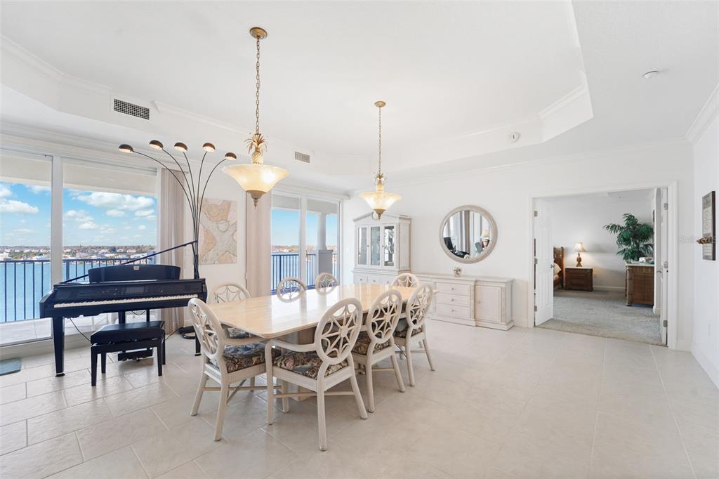17735 Gulf Boulevard, Unit 702 Redington Shores, FL 33708 - Photo 10 of 60 a view of a dining room with furniture a chandelier and wooden floor