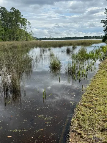 a view of a lake with a yard