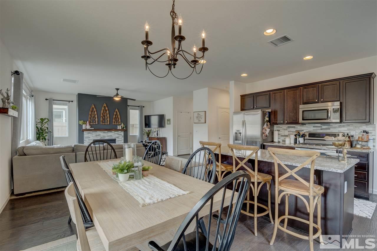 2810 Show Jumper Lane Reno, NV 89521 - Photo 9 of 38 a view of a dining room with furniture a kitchen and chandelier